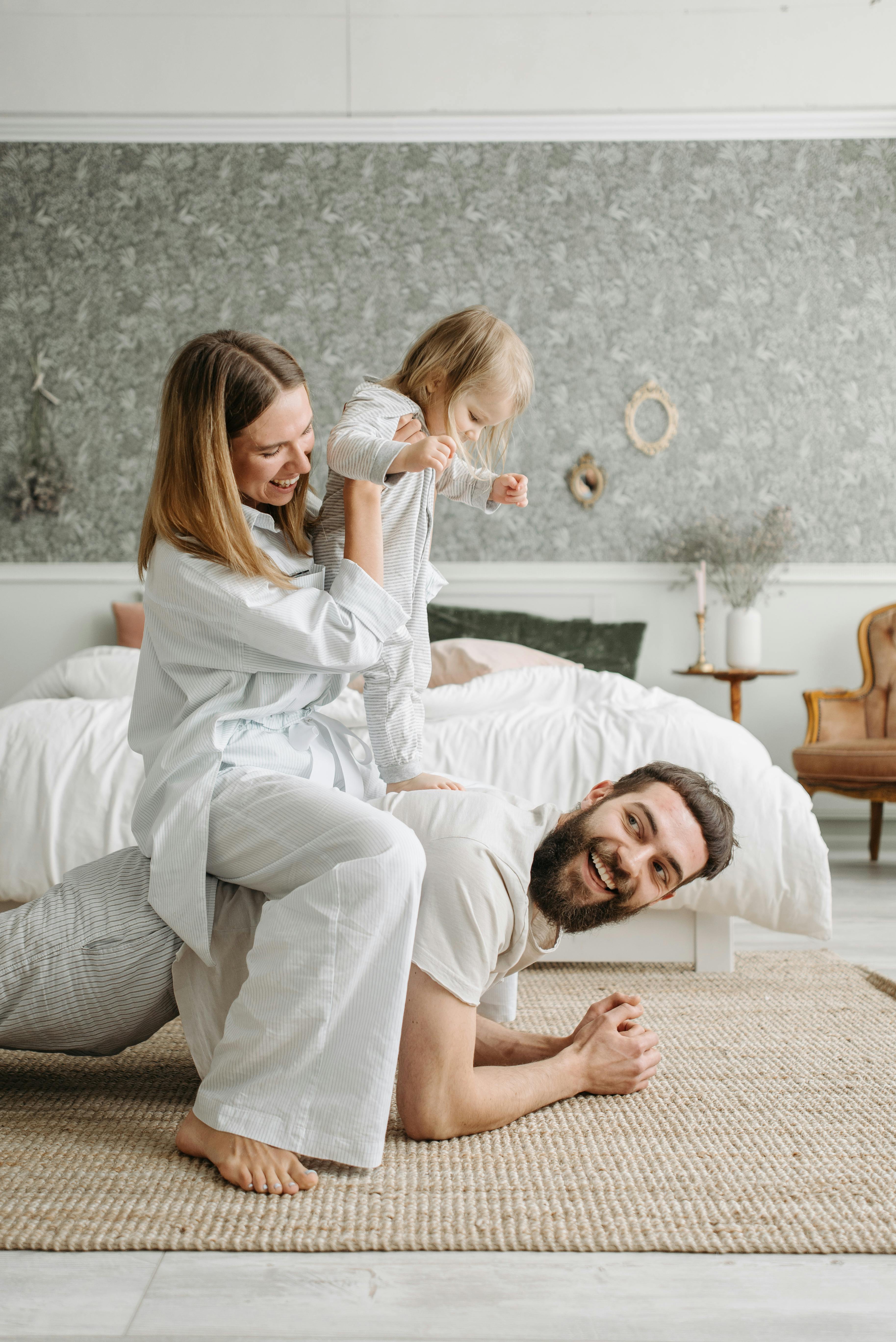 a couple spending time with their daughter inside the bedroom