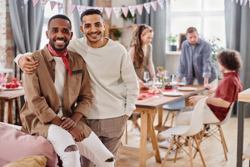 Free A diverse group of friends enjoying a casual indoor party with a relaxed atmosphere. Stock Photo
