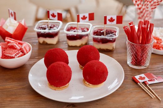 A vibrant display of Canadian-themed desserts featuring red and white treats perfect for celebrations.