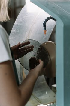Worker Smoothing a Round Glass Edges