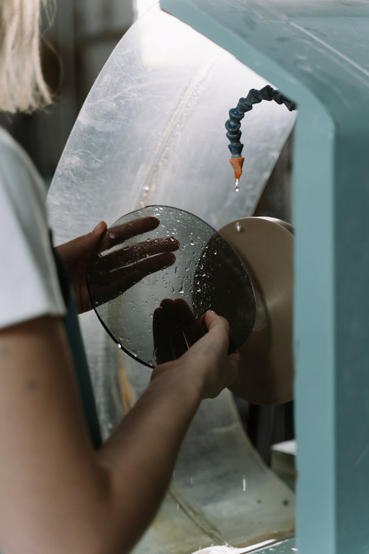 Worker Smoothing A Round Glass Edges