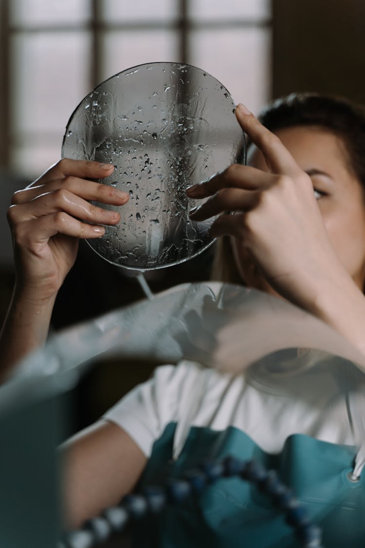 A Woman Holding A Wet Glass