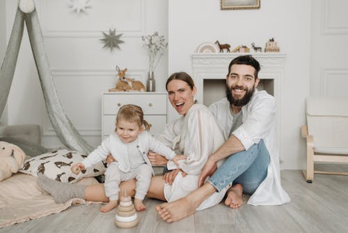 Free A Family Sitting on the Floor Stock Photo