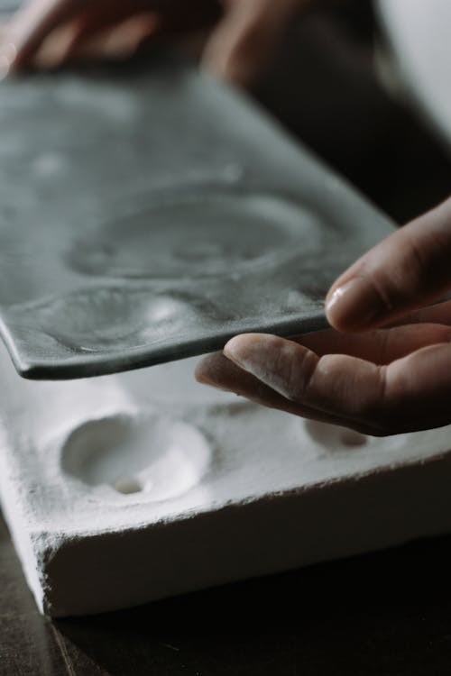 Person Holding Silver Square Container