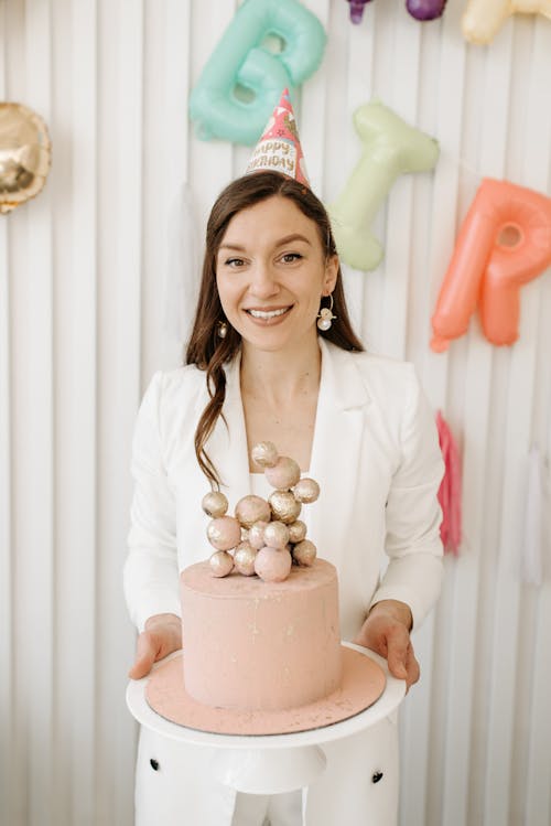 Free Woman in White Blazer Holding Cake Stock Photo