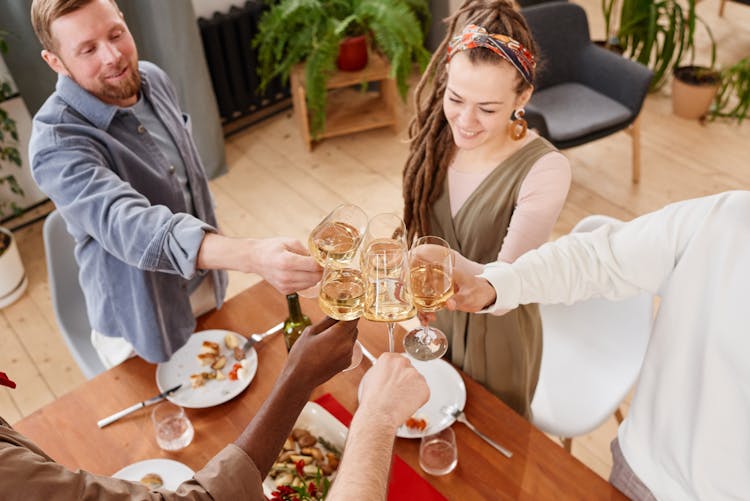 A Group Of People Doing A Toast