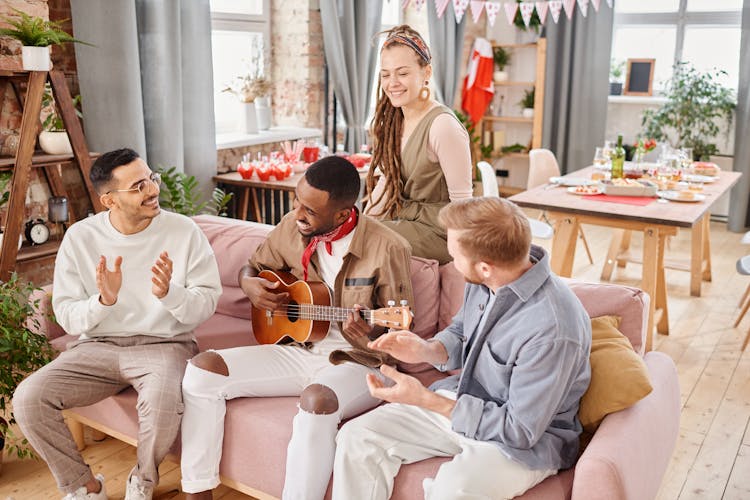 People Clapping While The Man Playing Guitar