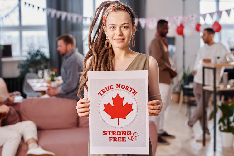 Pretty Woman With Dreadlock Hair Holding A Poster 