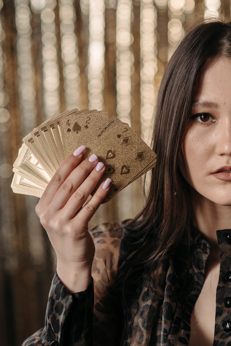 Close-Up Shot Of A Woman Holding Cards