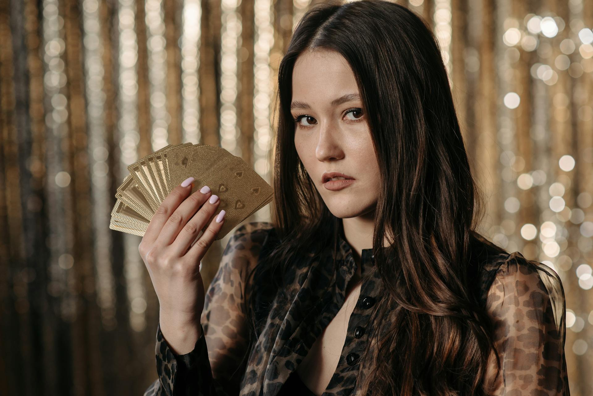 Brunette Woman Holding Gold Cards