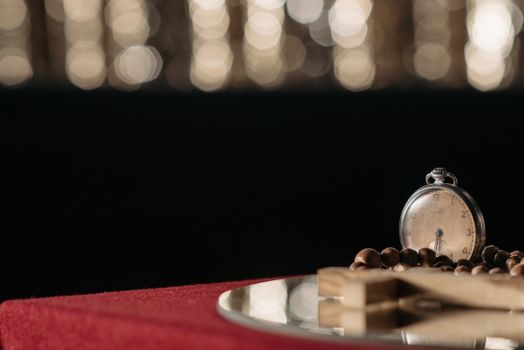 Close-up of a vintage pocket watch resting on a velvet surface, evoking mystery and nostalgia.