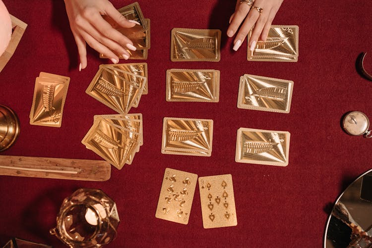 A Woman Playing With Gold Cards