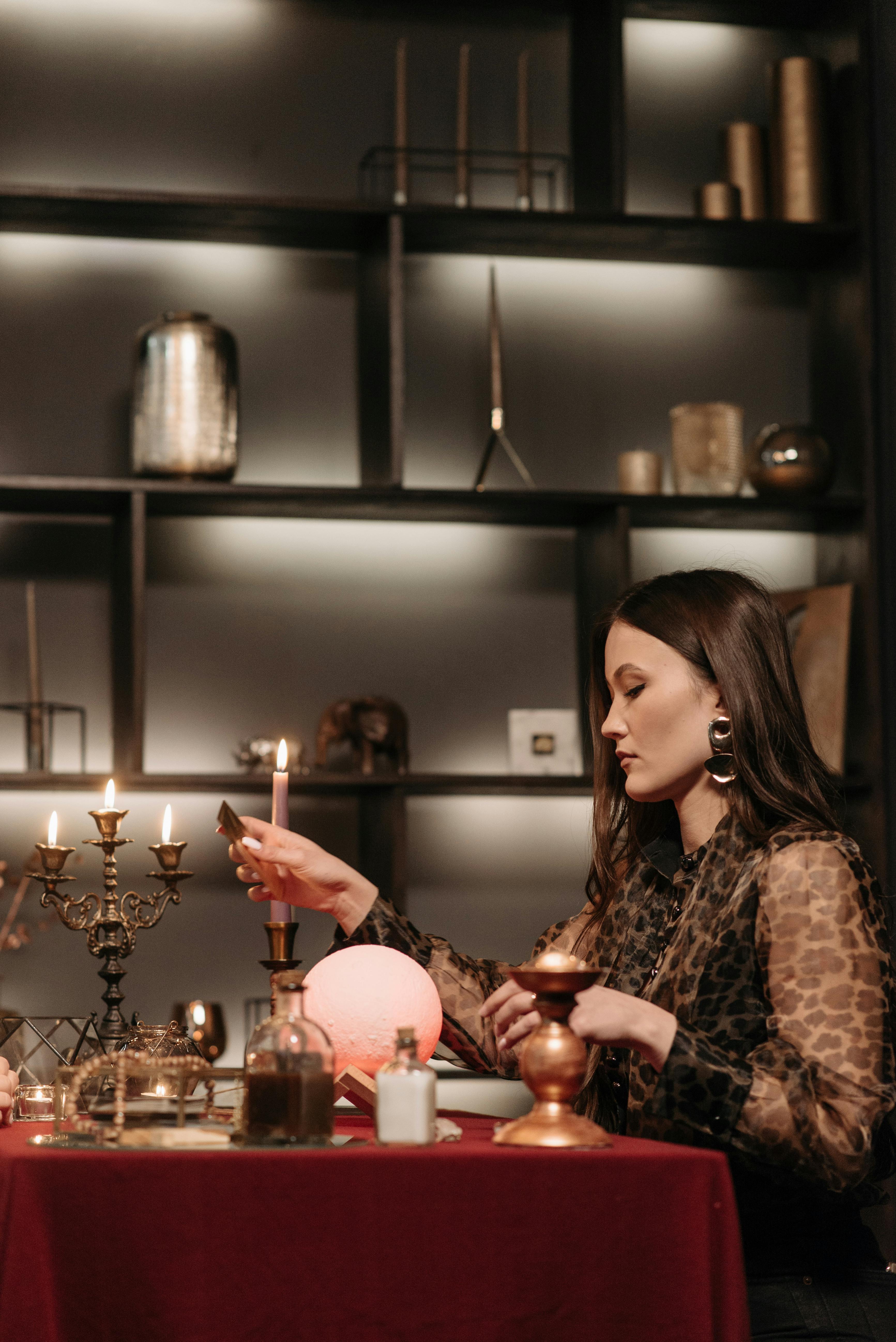 Fortune Teller sitting beside a Table full of Fortune Telling Objects