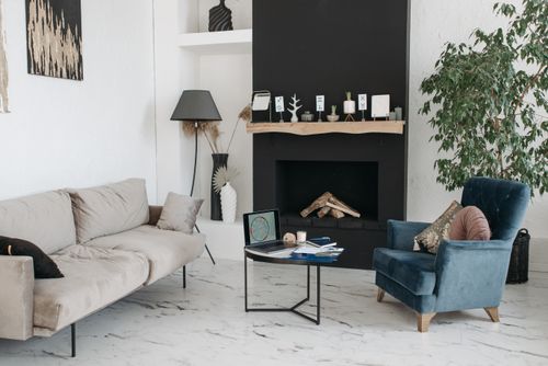 Free Spacious living room with a fireplace, armchair, and sofa in minimalist style. Stock Photo