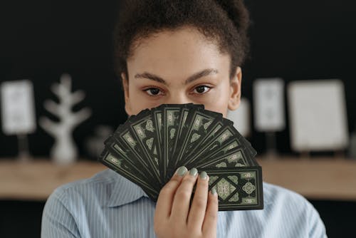 Portrait of Brunette Woman Holding Tarot Cards 