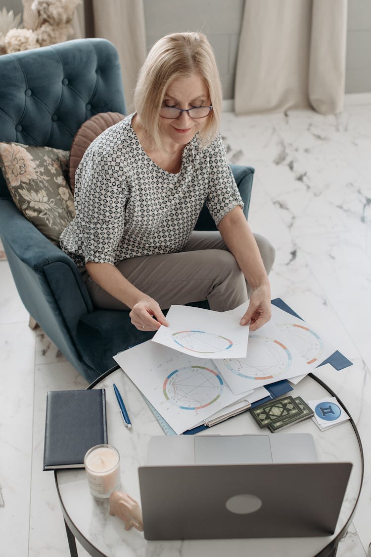 An Elderly Woman Looking At A Natal Chart