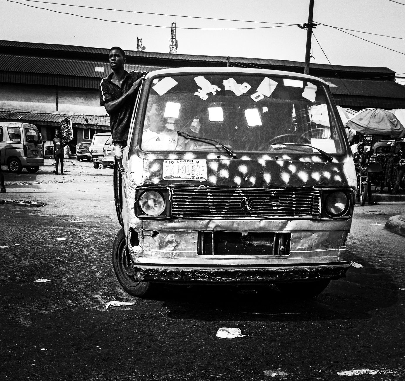 Yellow danfo minibus and Uber car in Lekki traffic