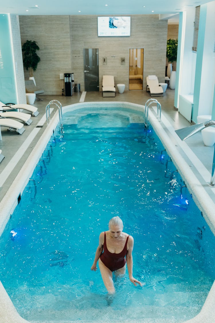 A Woman Swimming On The Pool