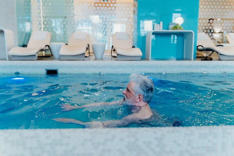 A Man Swimming On The Pool