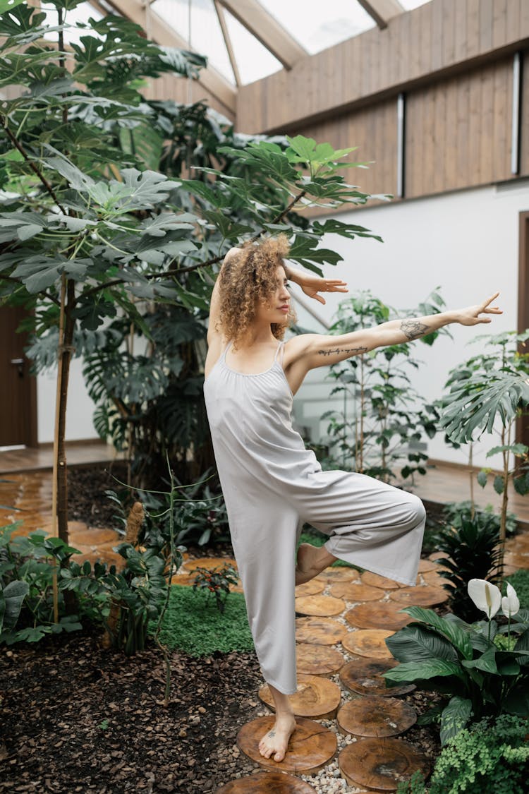 A Woman Balancing Her Body Using One Leg