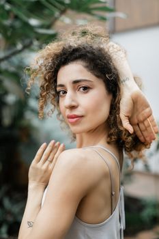 Beautiful portrait of a young woman with curly hair, showcasing natural beauty and confidence.