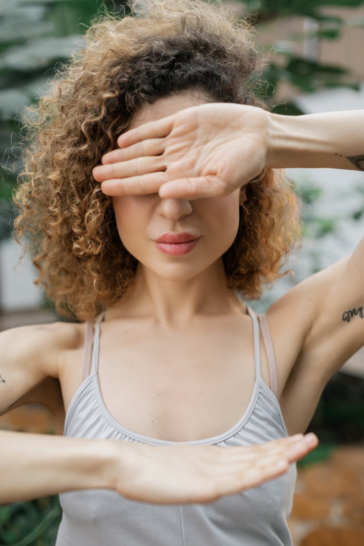 Young Woman With Curly Hair Making Gestures With Hands