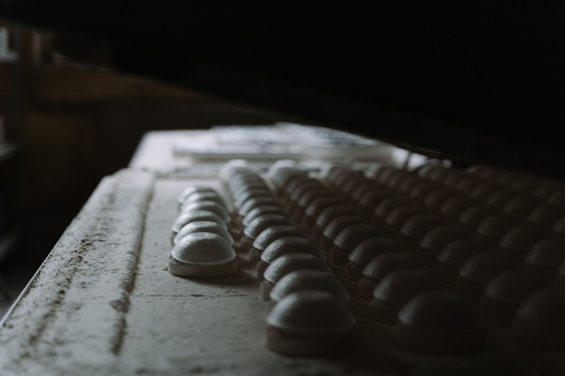 Rows of molded domes in a factory setting, showcasing industrial manufacturing processes.
