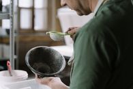 Person in Green Long Sleeve Shirt Holding Green Leaf