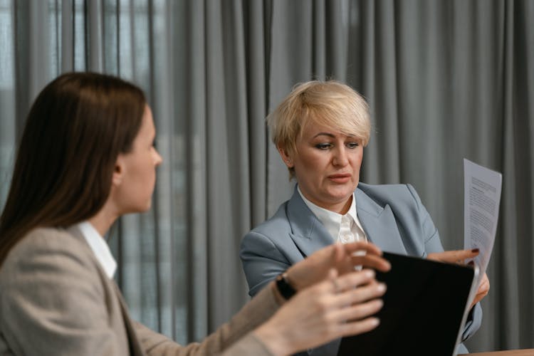 Two Women Talking In The Office