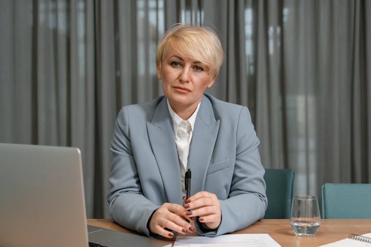 A Woman In Blue Coat Inside The Office