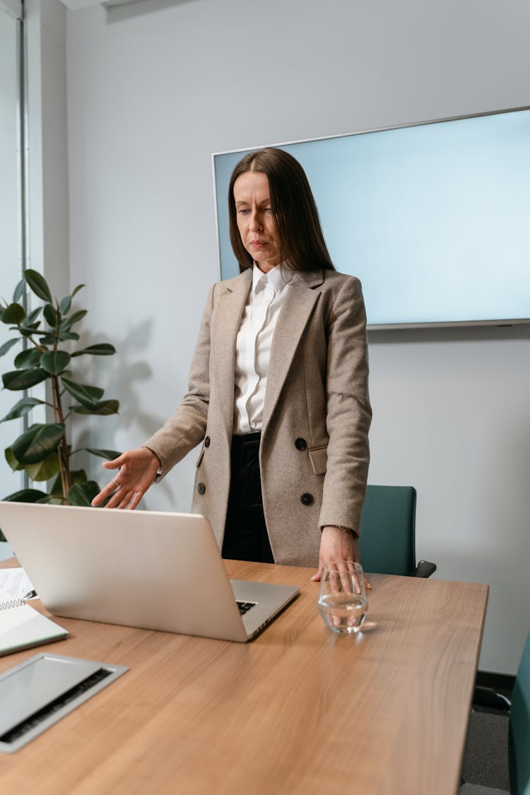 A Woman In Beige Coat In The Office