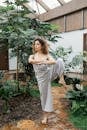 A Woman in Yoga Pose Standing with Leg Bended