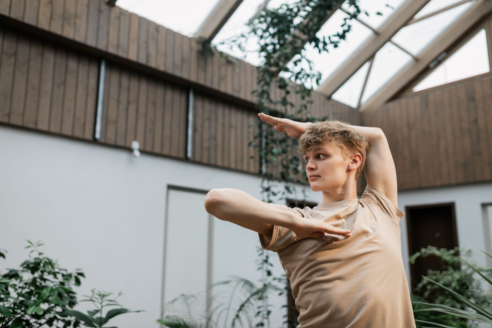 Man practicing a standing yoga pose outdoors during morning training