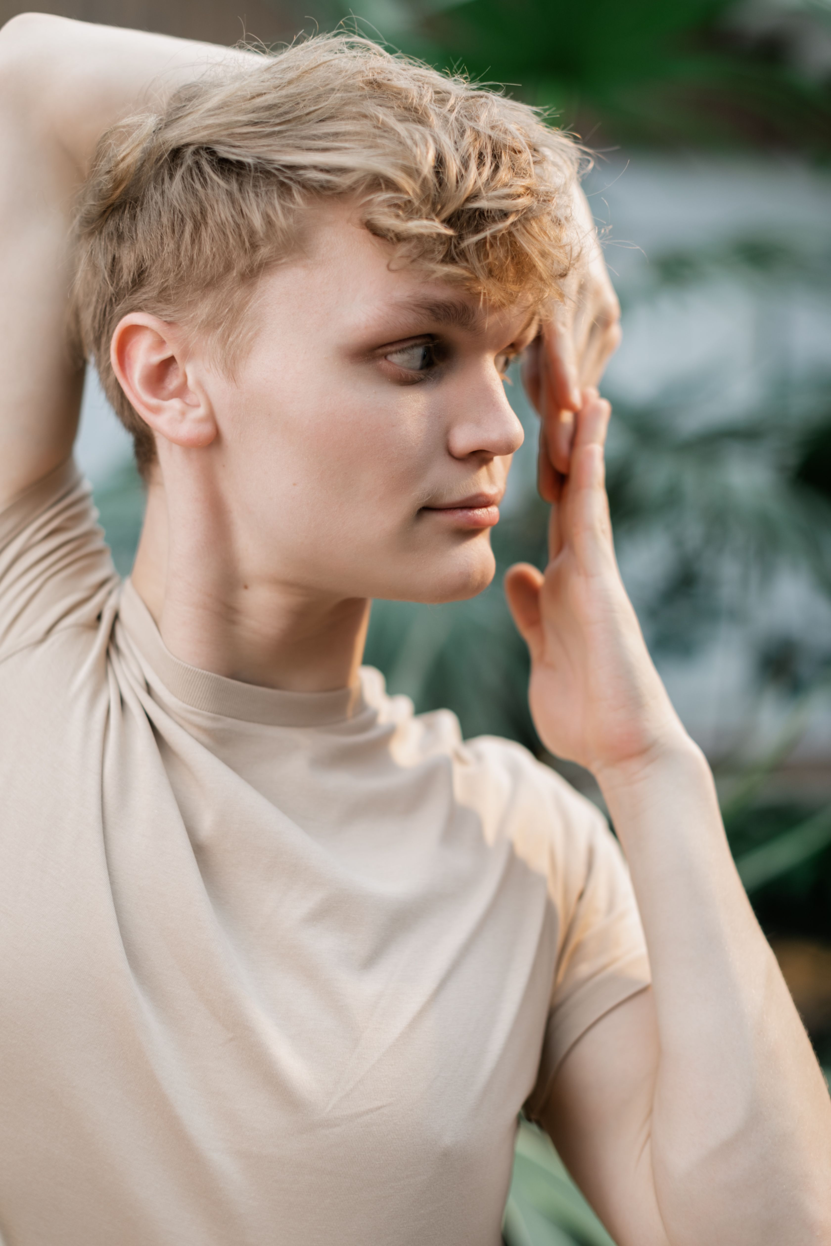 Blonde young man practicing yoga outdoors, embodying relaxation and mindfulness.