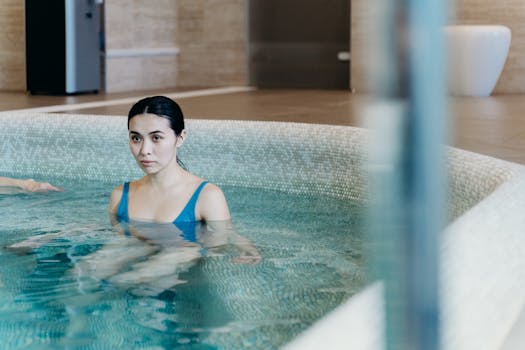 Calm woman enjoying leisure time in an indoor swimming pool. Perfect for lifestyle and wellness themes.