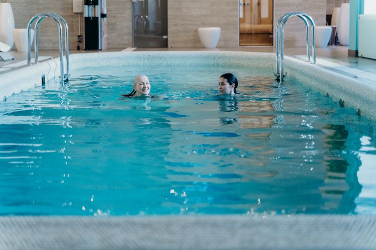 Photo Of Women Swimming In A Swimming Pool