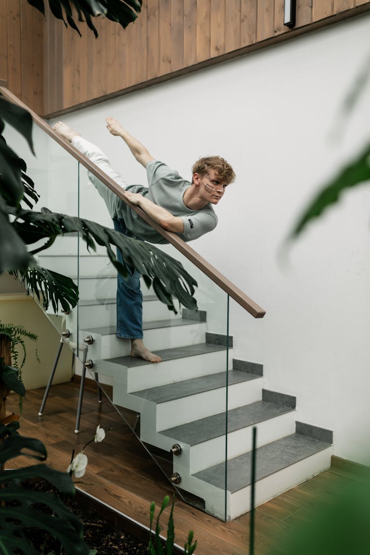 Young Man Standing On Stairs In A Dance Pose 