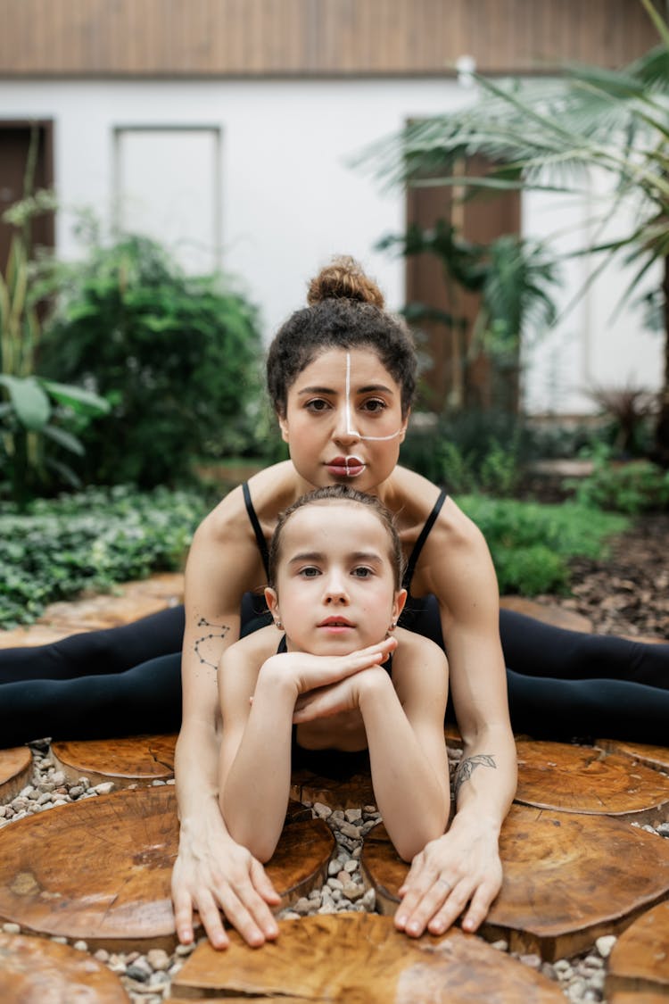 Mother And Daughter Exercising Together