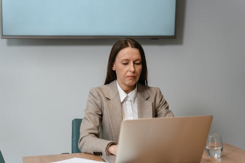 Free Photograph of a Woman Working on Her Laptop Stock Photo