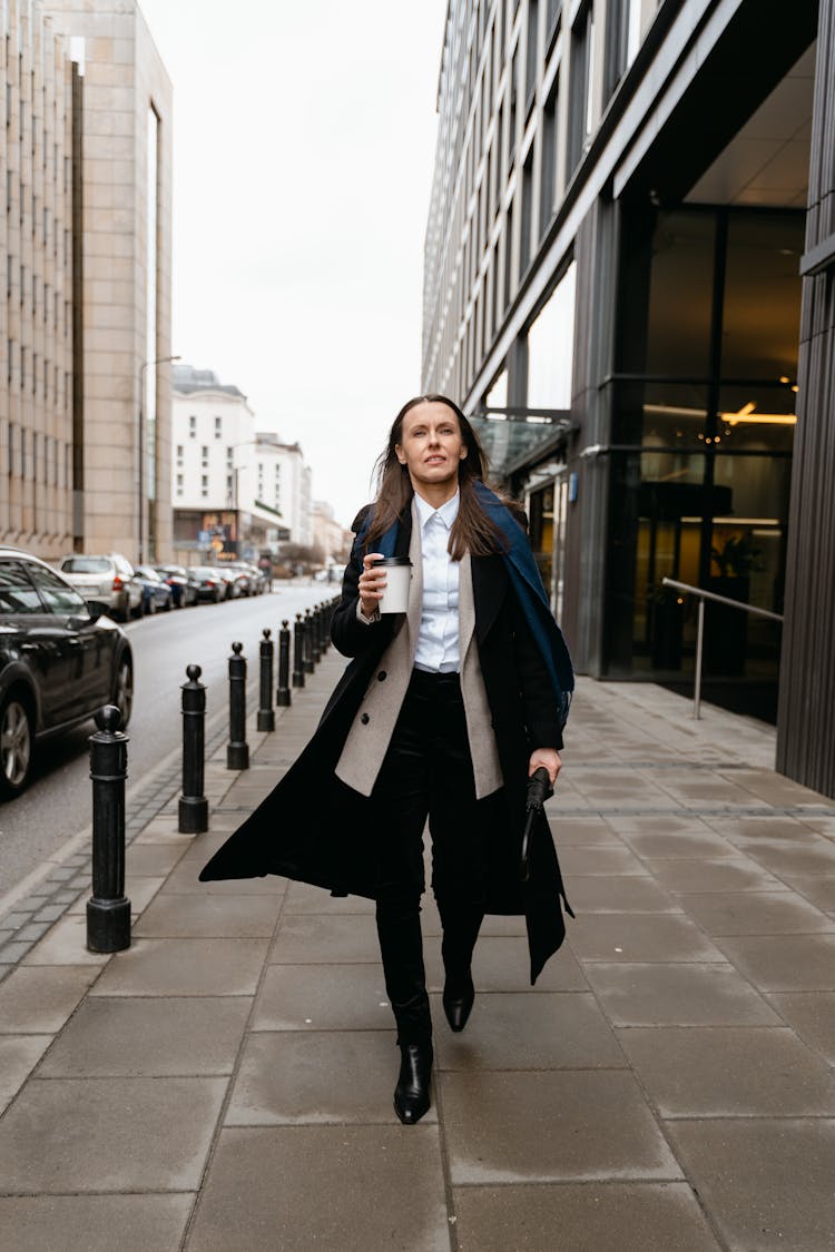 A Woman Walking On The Sidewalk