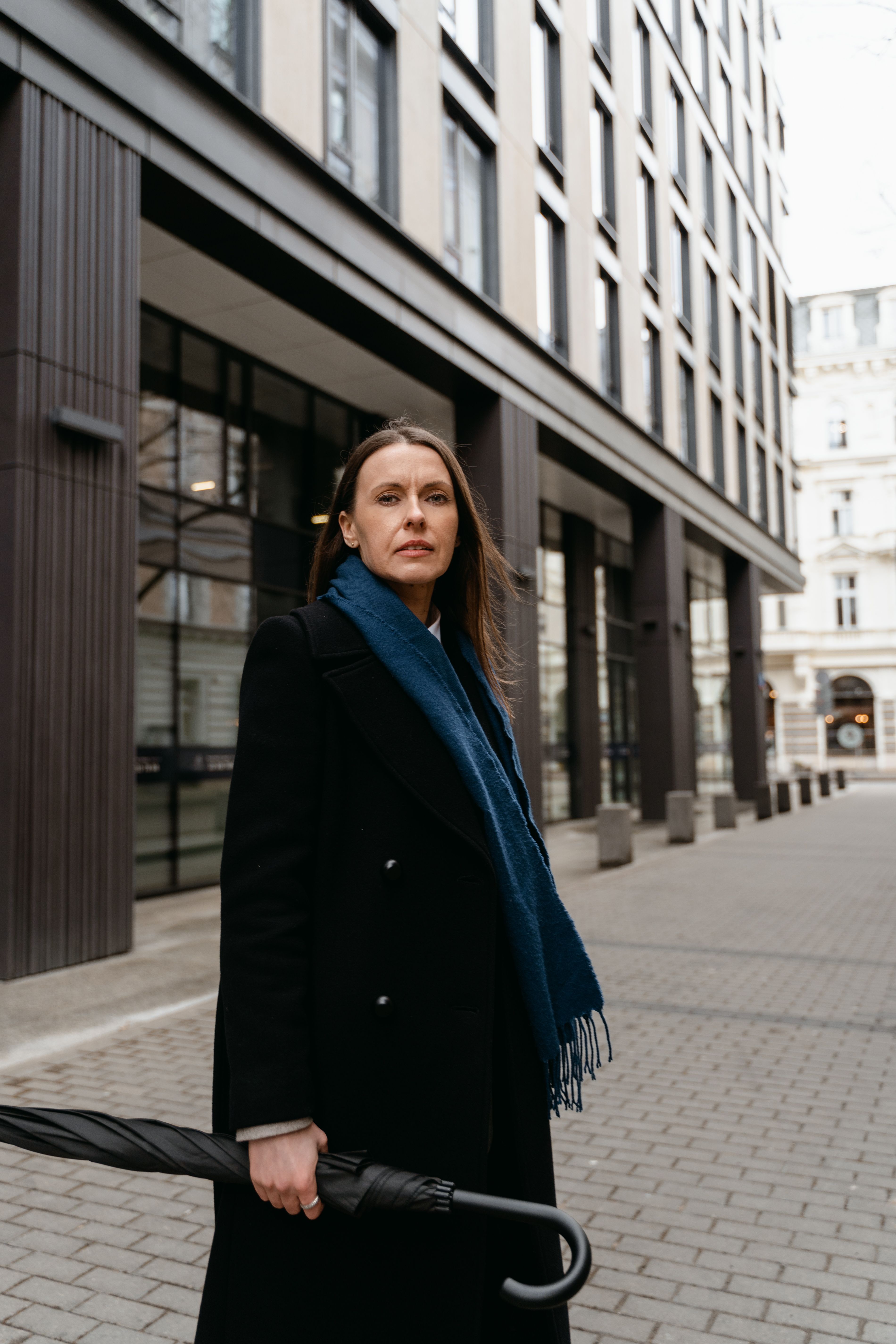 A Woman in Black Coat while Holding an Umbrella · Free Stock Photo