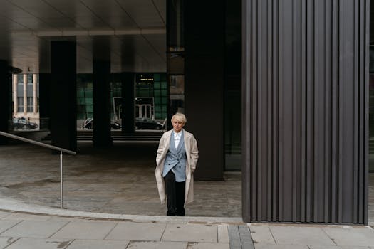 Confident businesswoman in formal wear standing outside modern office building.