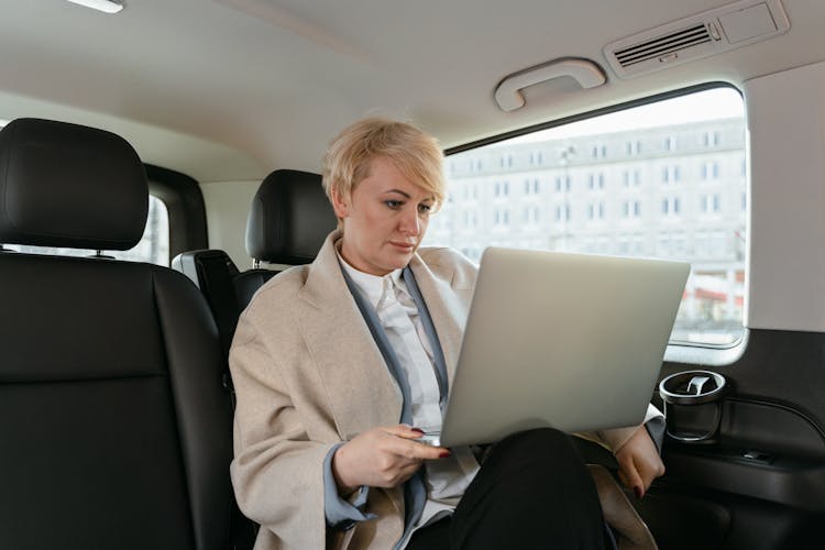 Woman Working While Sitting Inside Of A Car