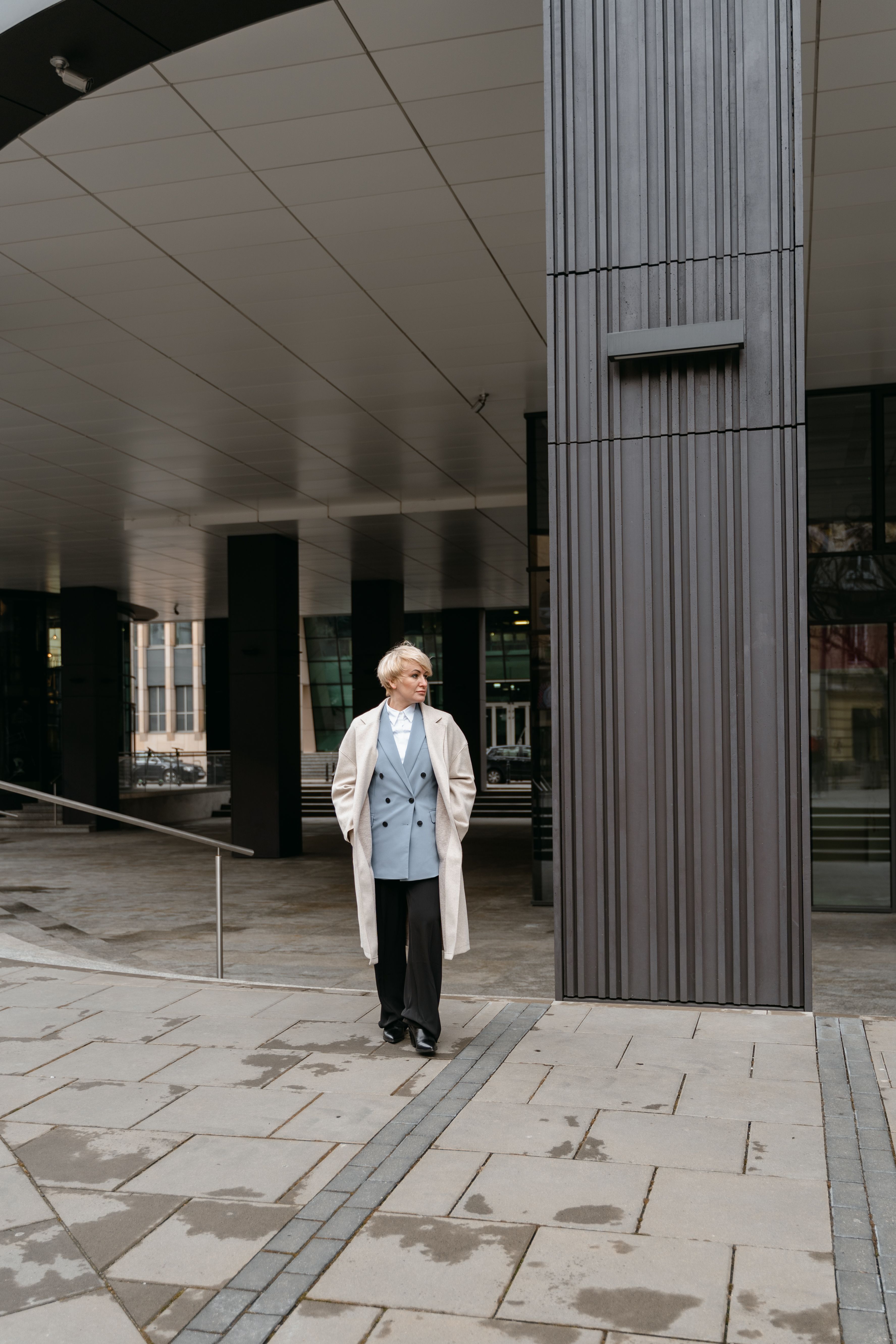 A Woman in White Coat Standing on the Street · Free Stock Photo