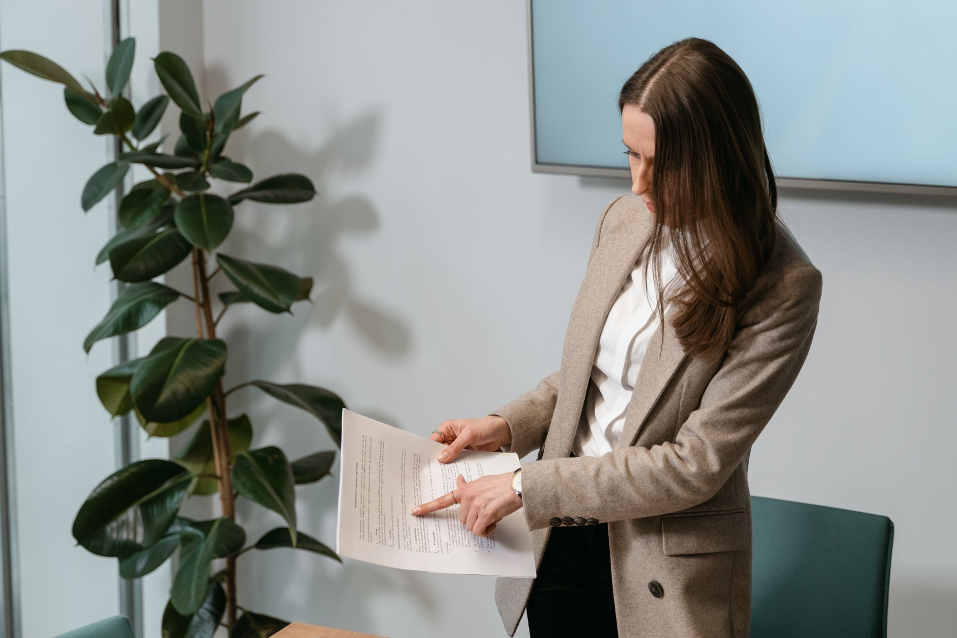 Compliance officer reviewing animal welfare regulations beside a laptop and printed cockfighting law timeline