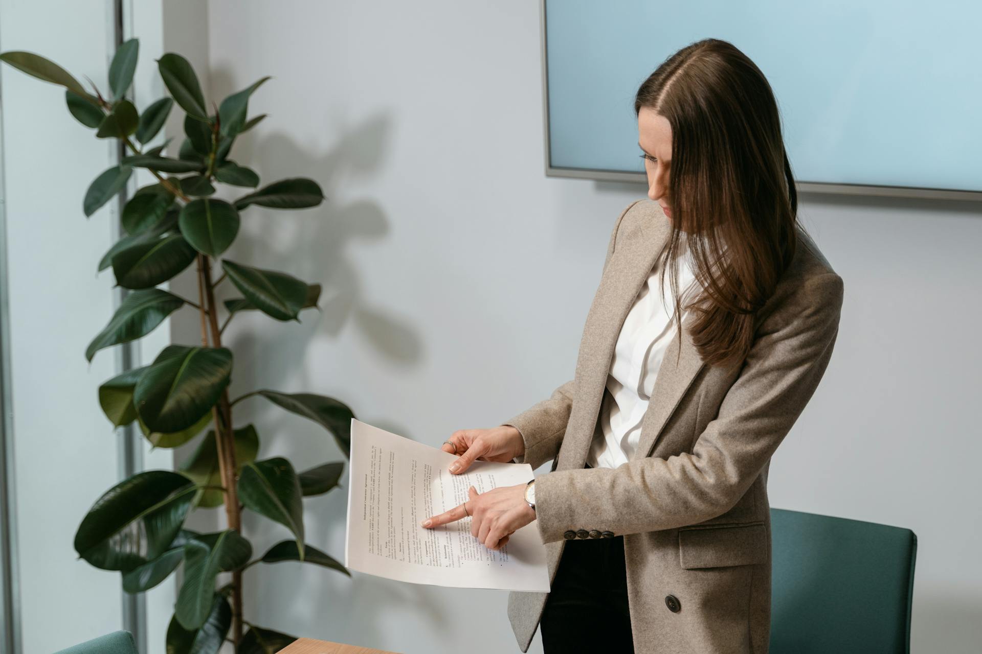 Woman Wearing a Blazer Holding a Document