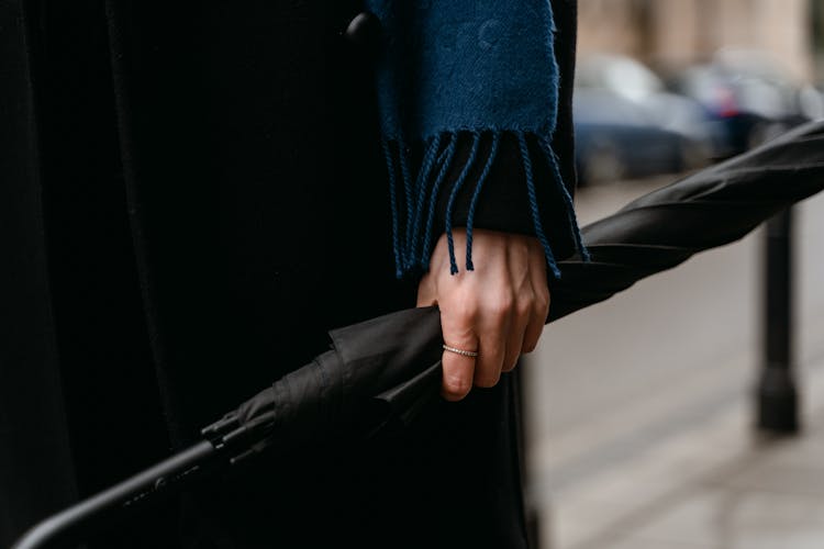 Person Holding A Black Umbrella