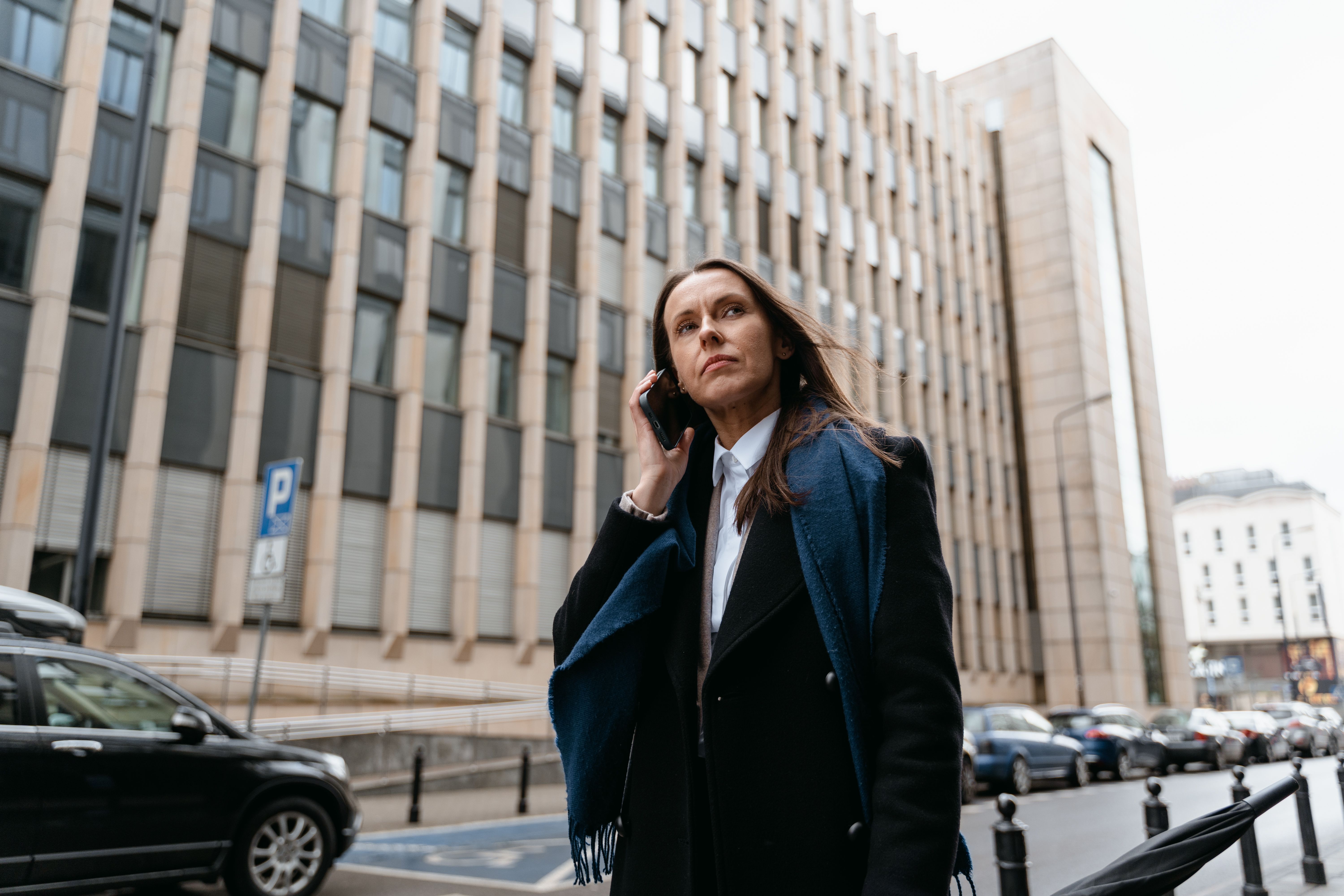 Free Woman in Black Blazer Standing Near Building Stock Photo