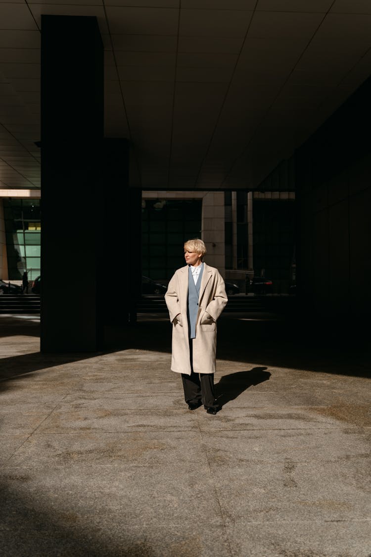 Woman Wearing A Coat Standing At The Foyer