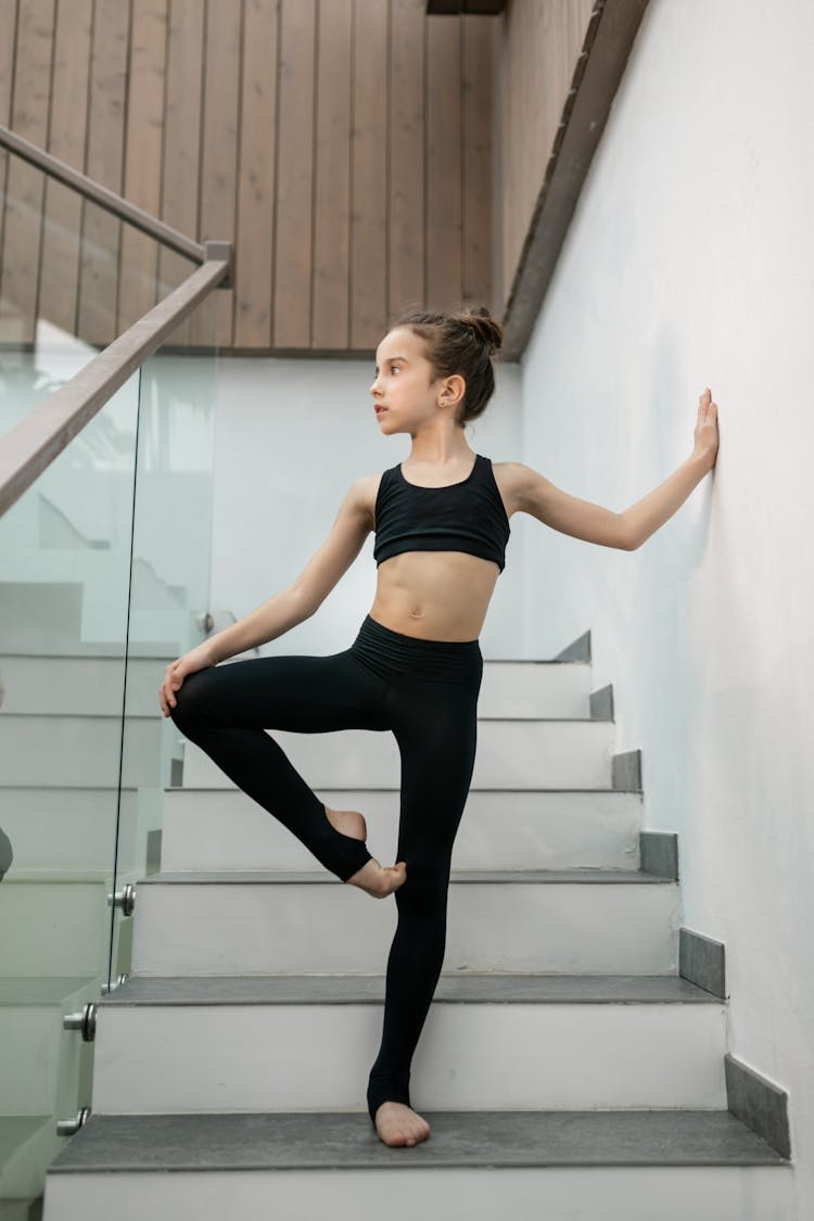 Little Gymnast Girl Standing On Stairs 